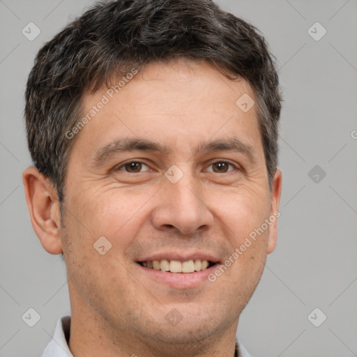 Joyful white adult male with short  brown hair and brown eyes