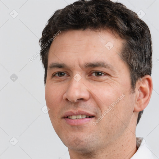 Joyful white adult male with short  brown hair and brown eyes