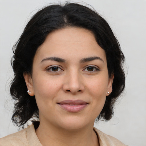 Joyful latino young-adult female with medium  brown hair and brown eyes