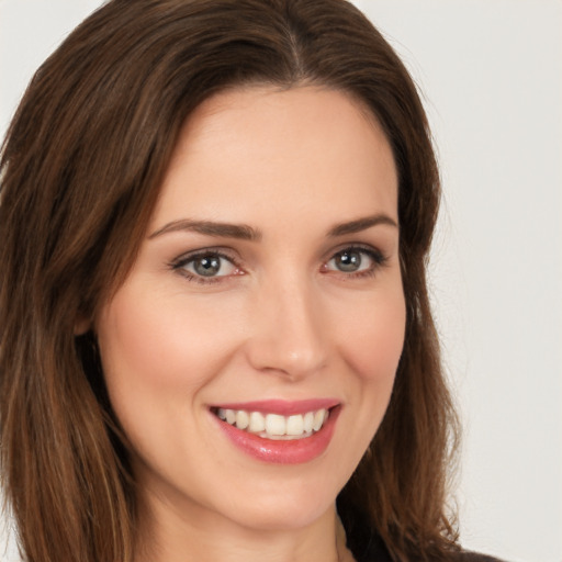 Joyful white young-adult female with long  brown hair and brown eyes