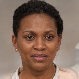 Joyful black adult female with short  brown hair and brown eyes