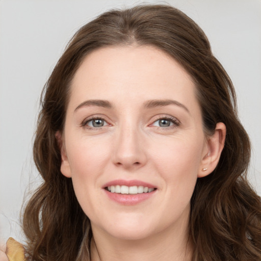 Joyful white young-adult female with long  brown hair and grey eyes