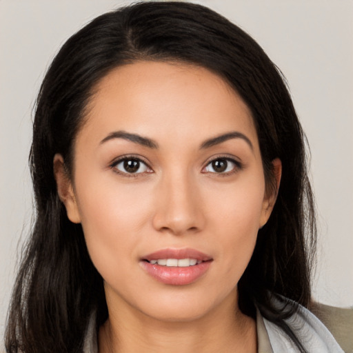 Joyful latino young-adult female with long  brown hair and brown eyes