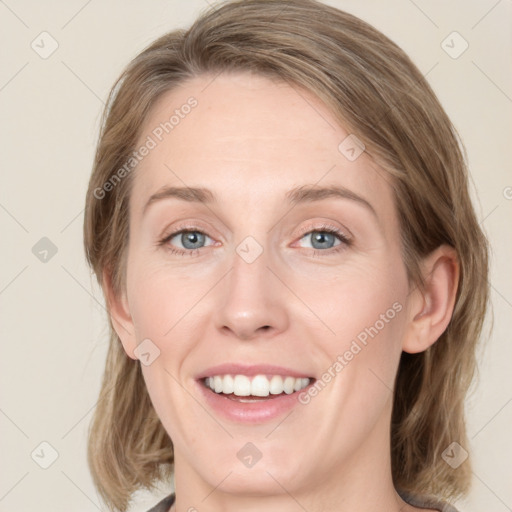 Joyful white young-adult female with medium  brown hair and green eyes