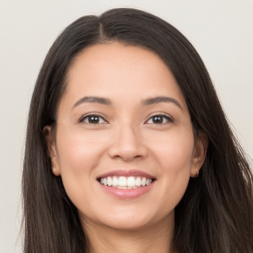 Joyful white young-adult female with long  brown hair and brown eyes