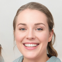 Joyful white young-adult female with medium  brown hair and blue eyes