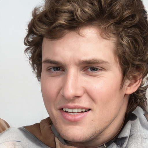 Joyful white young-adult male with short  brown hair and blue eyes