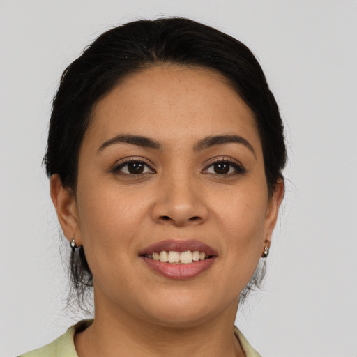 Joyful latino young-adult female with medium  brown hair and brown eyes