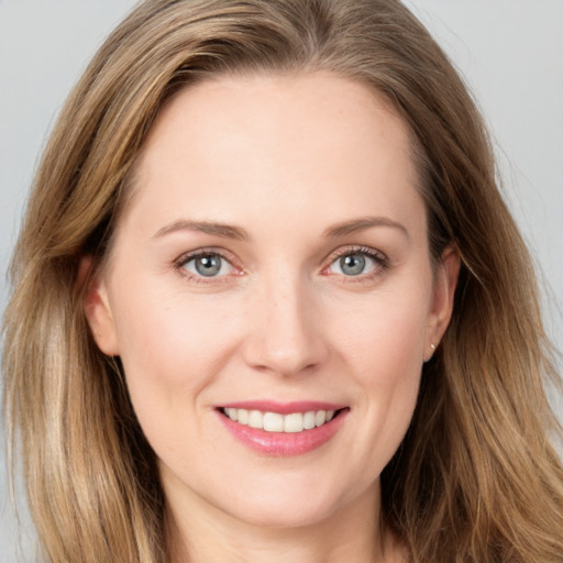 Joyful white young-adult female with long  brown hair and blue eyes