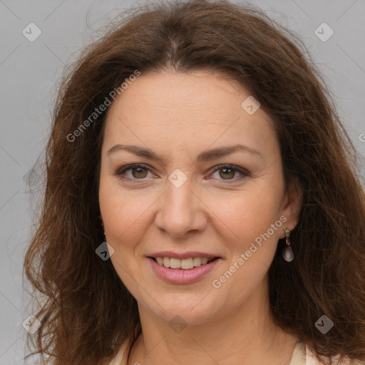 Joyful white adult female with long  brown hair and brown eyes