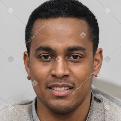 Joyful black young-adult male with short  black hair and brown eyes