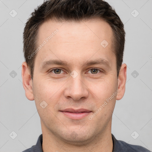 Joyful white adult male with short  brown hair and grey eyes