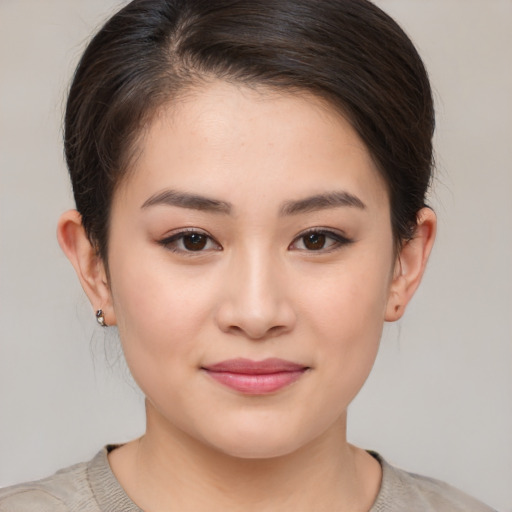 Joyful asian young-adult female with medium  brown hair and brown eyes