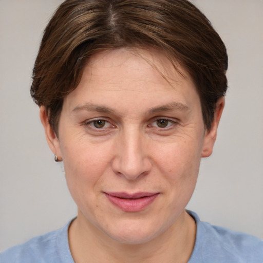 Joyful white adult female with short  brown hair and grey eyes