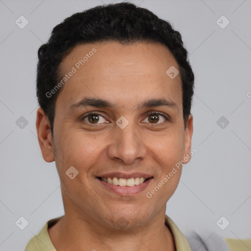 Joyful latino young-adult male with short  black hair and brown eyes