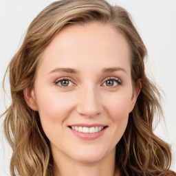 Joyful white young-adult female with long  brown hair and blue eyes