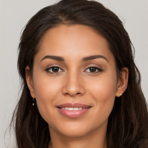 Joyful white young-adult female with long  brown hair and brown eyes