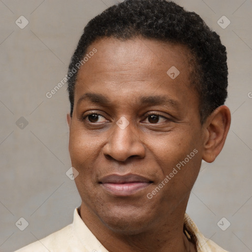 Joyful black adult male with short  black hair and brown eyes