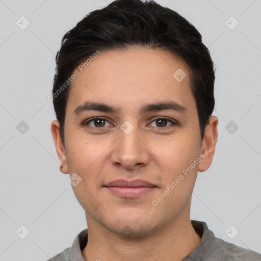 Joyful white young-adult male with short  black hair and brown eyes