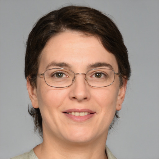 Joyful white adult female with medium  brown hair and green eyes