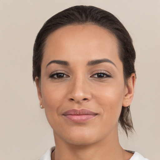 Joyful latino young-adult female with short  brown hair and brown eyes