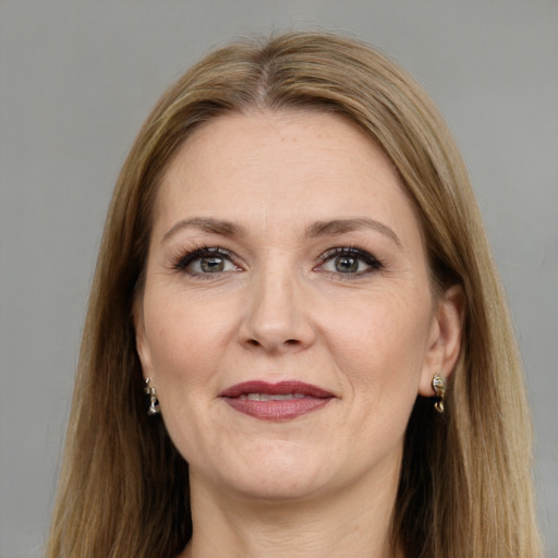 Joyful white adult female with long  brown hair and grey eyes