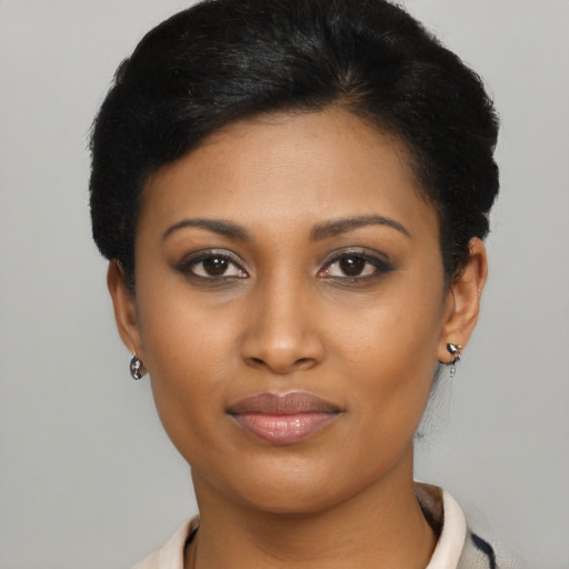 Joyful black young-adult female with short  black hair and brown eyes