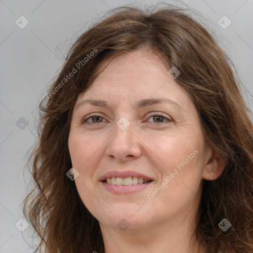 Joyful white adult female with long  brown hair and brown eyes