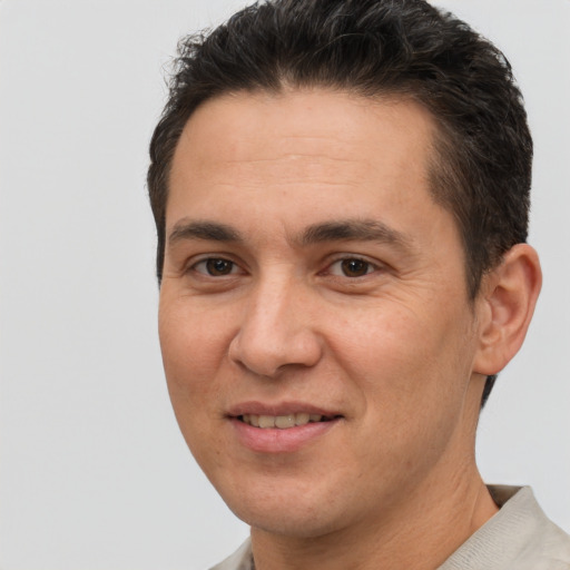 Joyful white adult male with short  brown hair and brown eyes