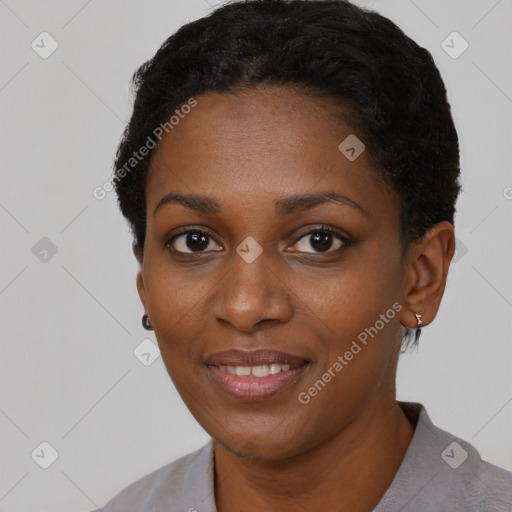 Joyful black young-adult female with short  black hair and brown eyes