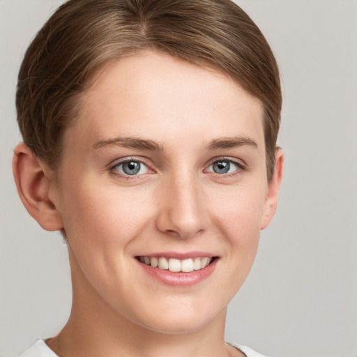 Joyful white young-adult female with short  brown hair and grey eyes