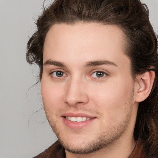 Joyful white young-adult male with medium  brown hair and brown eyes