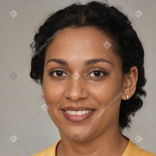 Joyful black adult female with medium  brown hair and brown eyes