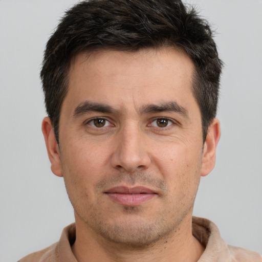 Joyful white young-adult male with short  brown hair and brown eyes