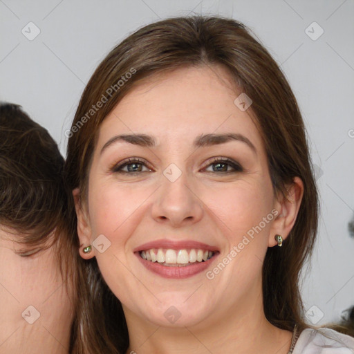 Joyful white young-adult female with long  brown hair and green eyes