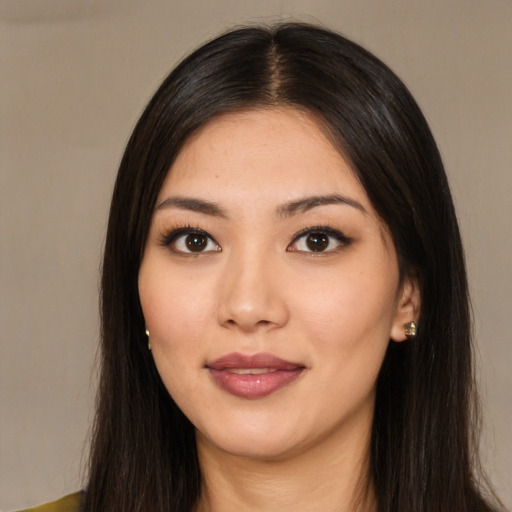 Joyful asian young-adult female with long  brown hair and brown eyes