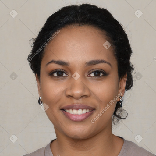 Joyful black young-adult female with short  black hair and brown eyes