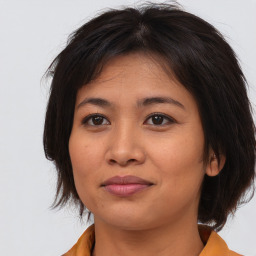 Joyful asian young-adult female with medium  brown hair and brown eyes