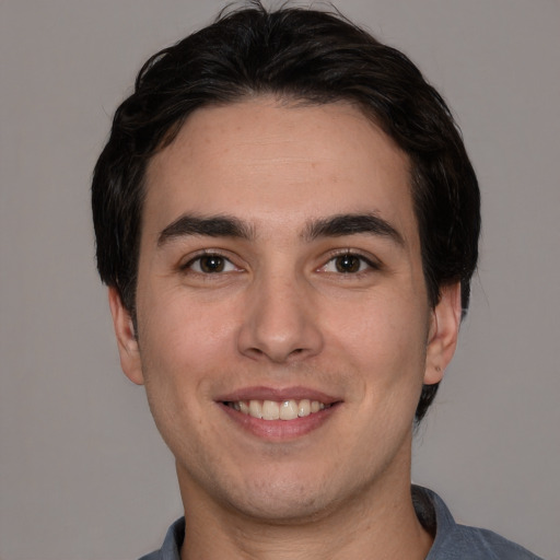 Joyful white young-adult male with short  black hair and brown eyes