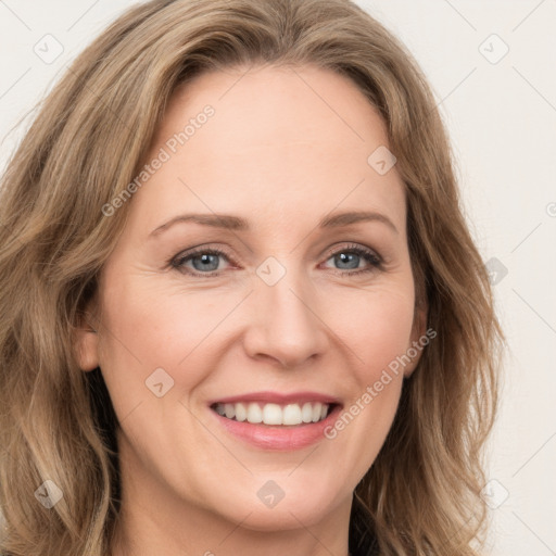 Joyful white adult female with long  brown hair and green eyes