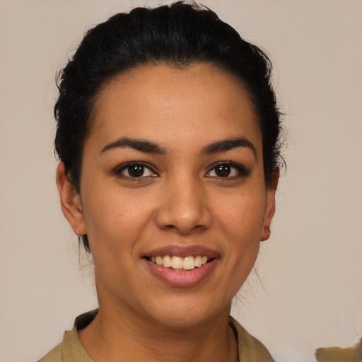 Joyful latino young-adult female with short  black hair and brown eyes