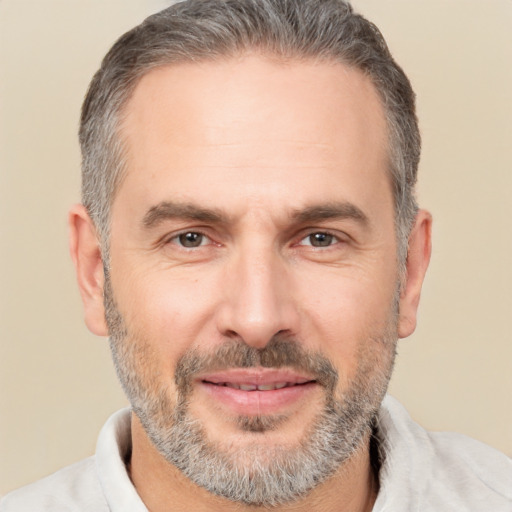 Joyful white adult male with short  black hair and brown eyes