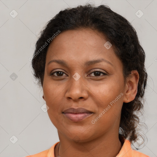 Joyful black adult female with medium  brown hair and brown eyes