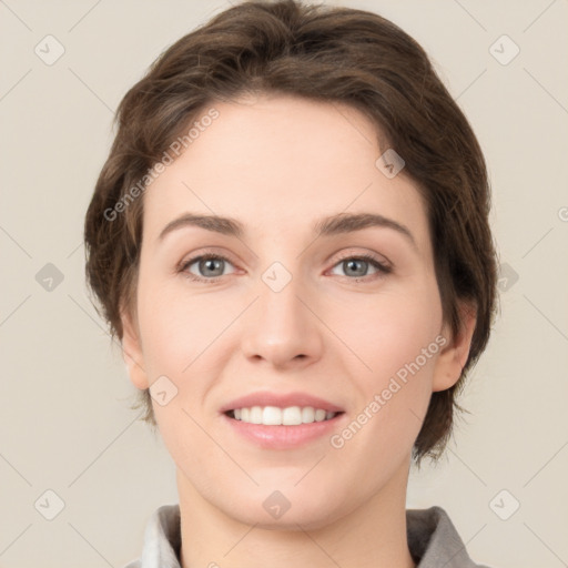 Joyful white young-adult female with medium  brown hair and grey eyes