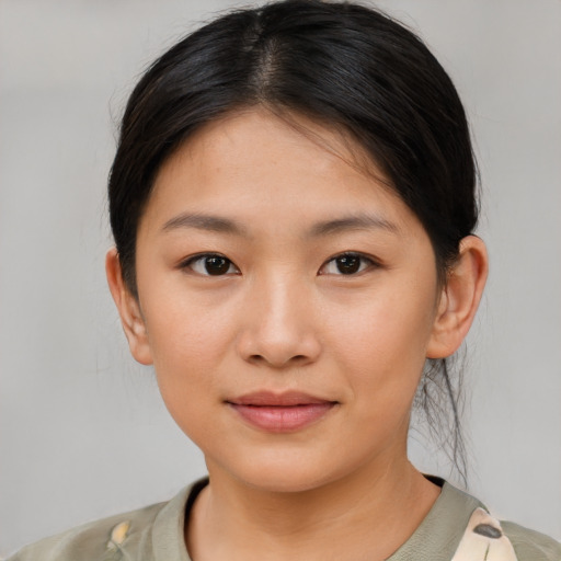 Joyful asian young-adult female with short  brown hair and brown eyes