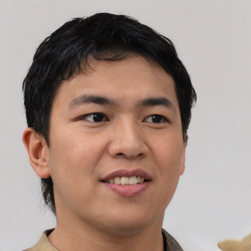 Joyful asian young-adult male with short  black hair and brown eyes