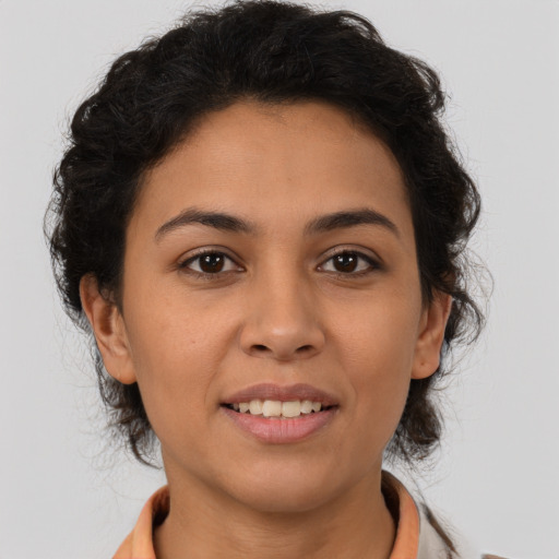Joyful latino young-adult female with medium  brown hair and brown eyes