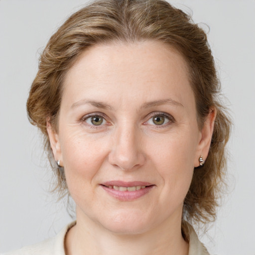 Joyful white adult female with medium  brown hair and grey eyes