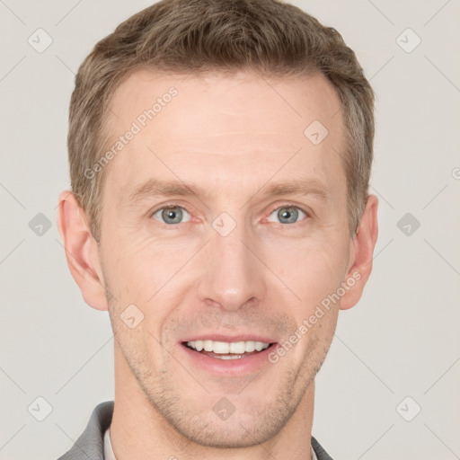 Joyful white adult male with short  brown hair and grey eyes