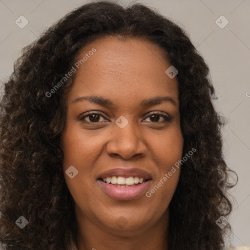 Joyful black young-adult female with long  brown hair and brown eyes